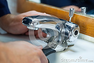 Close up of plumber repairing tap Stock Photo