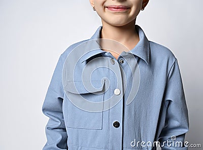 Close-up: a pocket on a denim jacket, overalls, a fragment of a photograph of a girl in a blue jacket with a patch Stock Photo
