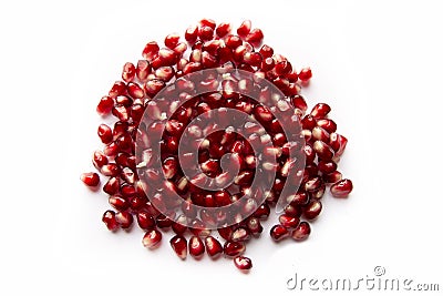 Red shiny pomegranate seeds on white background tasty and organic fruit peeled Stock Photo