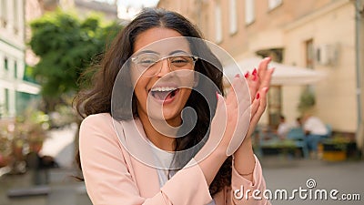 Close up portrait amazed excited happy Indian Arabian ethnic woman lady female businesswoman smiling laughing applauding Stock Photo