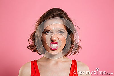 Close-up portrait of angry young woman with red lips looking at Stock Photo