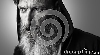 Portrait of an attractive man with a grey beard and a hood Stock Photo