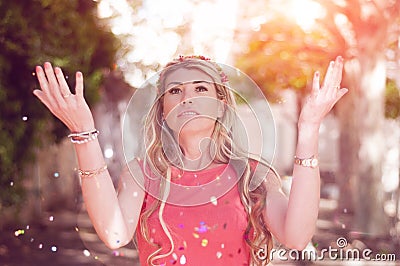 Close up portrait of attractive young woman throwing glitters. C Stock Photo