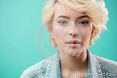 Close up portrait of beautiful blond woman wearing fashion denim jacket Stock Photo