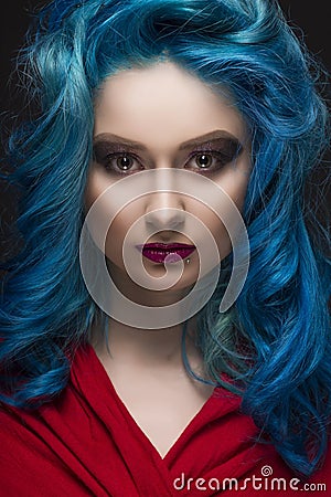 Close-up portrait of beautiful dyed blue colour hair girl wearing red scarf Stock Photo