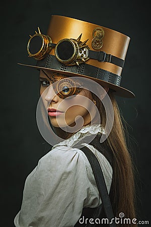 Close-up portrait of a beautiful girl steampunk, hat and eyecup. Stock Photo