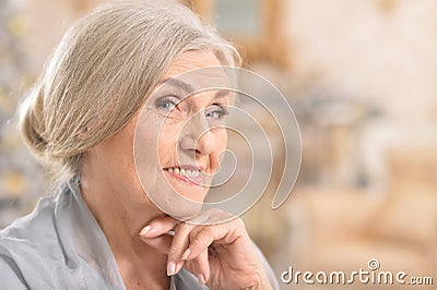 Portrait of beautiful senior woman smiling at home Stock Photo