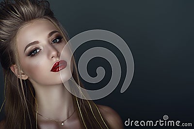 Close up portrait of beautiful young blond model with perfect provocative make up and stylish hairstyle Stock Photo