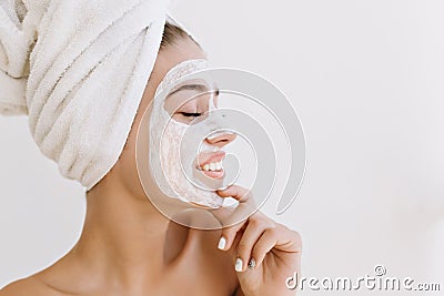 Close-up portrait beautiful young woman smiling with towels after take bath make cosmetic mask on her face. Rejuvenation Stock Photo