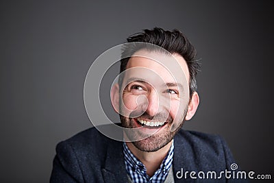 Close up businessman with beard smiling and looking up Stock Photo