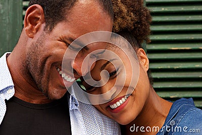 Close up cheerful couple in love smiling on green background Stock Photo