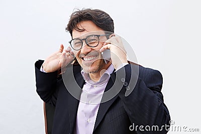 Cheerful middle aged businessman with glasses talking on mobile phone Stock Photo