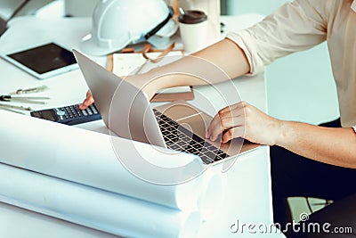 Close up portrait of civil engineer using laptop to planning pr Stock Photo