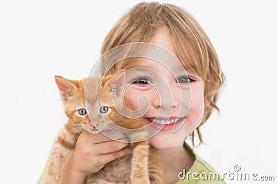 Close-up portrait of cute boy holding kitten Stock Photo