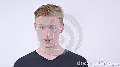 Close up portrait of cute teen boy looking aside with hand on face.Isolated on white background. Close up portrait of cute teen boy looking aside with hand on stock footage Close up portrait of cute teen boy looking aside with hand on face.Isolated on white background. Close up portrait of cute teen boy looking aside with hand on stock footage
