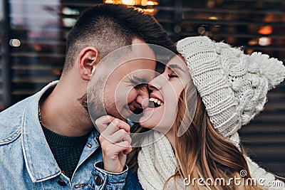 Close-up portrait of debonair woman in knitted hat playfully posing with boyfriend. Cute european couple fooling around Stock Photo