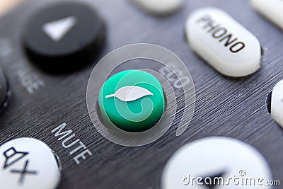 A close up portrait of an eco button on a remote control to turn a device into its ecologic environment friendly and power saving Editorial Stock Photo