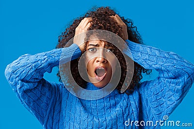 Close-up portrait embarrassed and shocked, panicking young woman made huge mistake and regret it, staring alarmed and Stock Photo