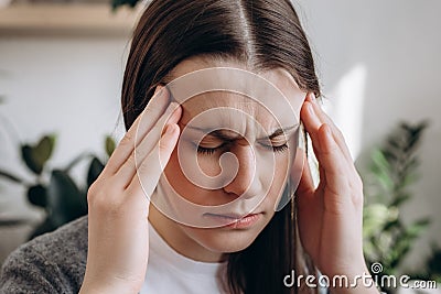 Close up portrait of frustrated depressed young girl feel stress anxiety, worried tired upset lady suffer from feeling unwell Stock Photo