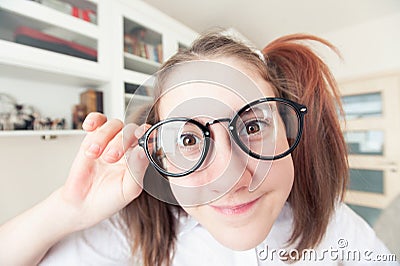 Portrait of funny pretty nerdy girl with ponytails in glasses Stock Photo