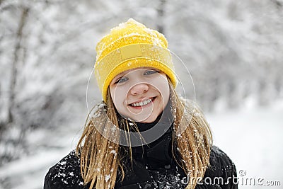 Close up portrait of funny happy teenage girl in yellow knitted hat Stock Photo