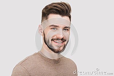 Close-up portrait of handsome smiling young man. Laughing joyful cheerful men studio shot. Isolated on gray background Stock Photo