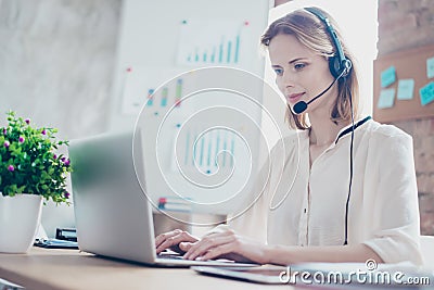 Close up portrait of happy smiling confident experienced qualified young professional operator of call center, she is sitting Stock Photo