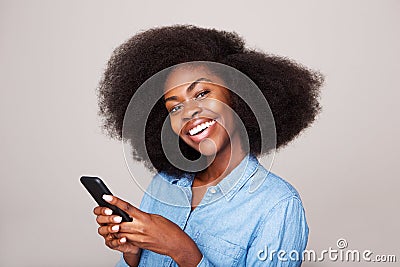 Close up portrait of happy young african american woman smiling with mobile phone Stock Photo