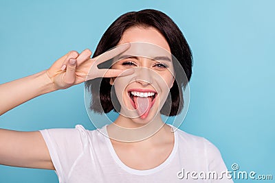 Close-up portrait of her she nice attractive cheerful cheery positive glad naughty girl showing v-sign tongue out Stock Photo