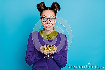 Close-up portrait of her she nice attractive girlish hungry cheerful cheery girl holding in hands bowl caramel candy Stock Photo