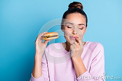 Close-up portrait of her she nice attractive lovely pretty dreamy hungry cheery girl enjoying eating beef burger licking Stock Photo