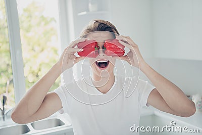 Close-up portrait of his he nice attractive cheerful glad cheery comic childish funky guy closing eyes with fresh red Stock Photo