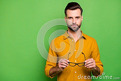Close-up portrait of his he nice attractive serious bearded brown-haired guy in casual formal shirt holding in hands Stock Photo