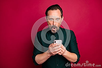 Close-up portrait of his he nice attractive wondered shocked brunette man using cell reading news post isolated on Stock Photo