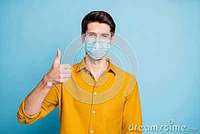 Close-up portrait of his he nice confident healthy guy wearing safety mask showing thumbup mers cov flu grippe Stock Photo