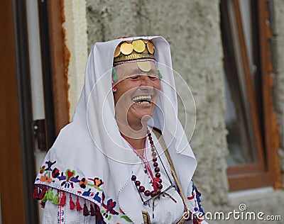 Portrait image of older woman laughing gaily wearing traditional village tribal clothing with headpiece Editorial Stock Photo