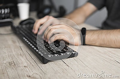 Close up portrait of male hands typing on computer keyboard. Stock Photo