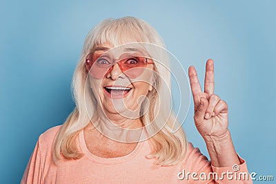 Close up portrait of mature funny lady showing v-sign Stock Photo