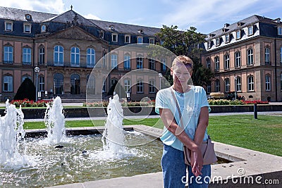 Close up portrait mature woman at the Schlossplatz Fountain in Stuttgart Stock Photo