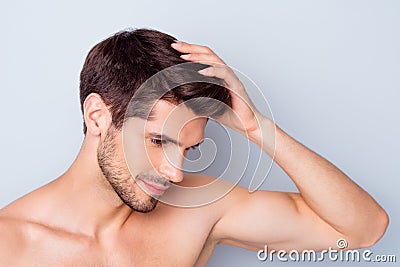 Close-up portrait of nice attractive stylish confident peaceful bearded brown-haired guy touching silky healthy shine Stock Photo