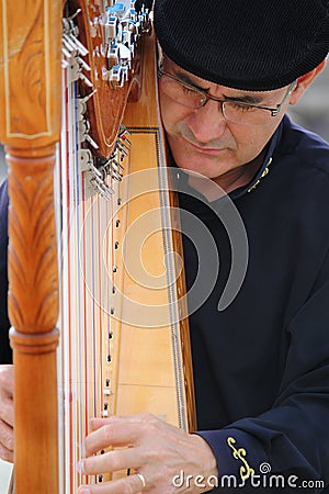 Portrait passion of busker musician playing harp F Editorial Stock Photo