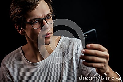 Close up portrait of pleasant programmer with mobile phone. Stock Photo