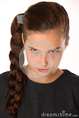 Close-up portrait of pretty young schoolgirl. She is serious and demanding Stock Photo