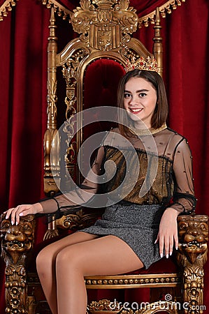 Close up portrait of queen sitting on throne with flower Stock Photo