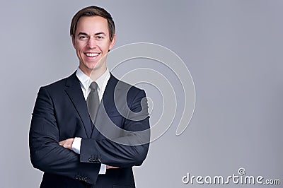 Close up portrait of a relaxed business man smiling with arms crossed Stock Photo