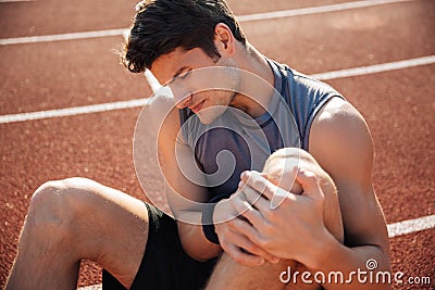 Close up portrait of a runner suffering from leg cramp Stock Photo