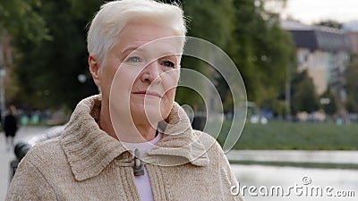 Close up portrait sad serious attractive benevolent woman of retirement age. Calm brooding mature lady in casual clothes Stock Photo