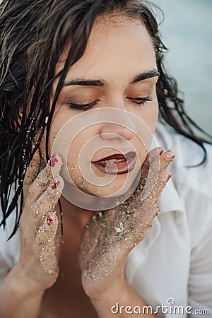 Close up portrait of sensual young woman with sand Stock Photo