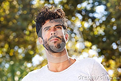 Close up serious handsome man with beard outside in nature Stock Photo