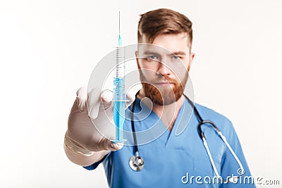 Close up portrait of a serious surgeon holding a syringe Stock Photo